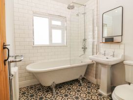 A bathroom with a bathtub and sink at Afallon in Llanbedrog