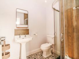 A bathroom with a sink and shower at Afallon in Llanbedrog