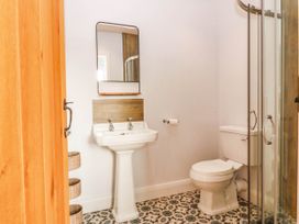 A bathroom with a sink, toilet, and shower at Afallon in Llanbedrog