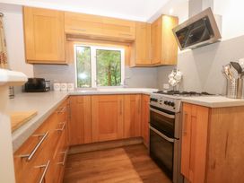 A kitchen with cabinetry and appliances at Orchard Lodge in Bolney