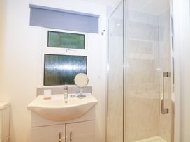A bathroom with a sink and shower at Orchard Lodge, Bolney