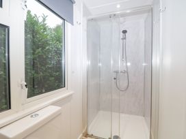 A bathroom with a shower and toilet at Orchard Lodge in Bolney