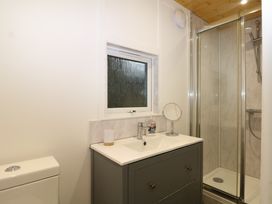 A bathroom with a sink and shower at Harvest Lodge Wineham near Bolney