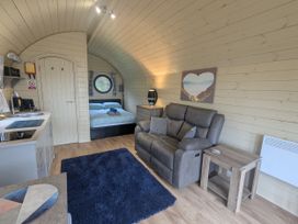 A studio with a sofa, kitchenette, and bed at Stapeley Pod White Grit near Chirbury