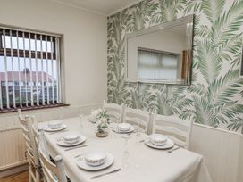 A dining room with a table and chairs at Beachcrest in Whitby
