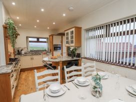 A kitchen with a table and chairs at Beachcrest in Whitby