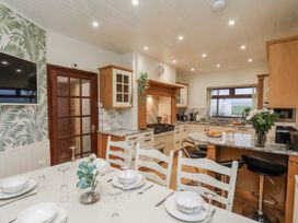 A kitchen with a dining table and chairs at Beachcrest in Whitby