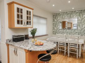 A kitchen with a dining area and food on the table at Beachcrest in Whitby