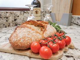 Bread and tomatoes on a cutting board at Beachcrest in Whitby