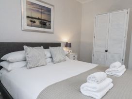 A bedroom with a bed and towels at Beachcrest in Whitby