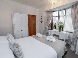 A bedroom with a bed and a mirrored table at Beachcrest in Whitby