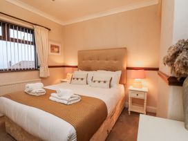 A bedroom with a bed and nightstand at Beachcrest in Whitby