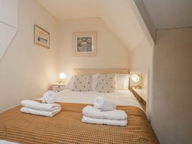 A bedroom with a bed and towels at Beachcrest in Whitby