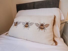 A pillow with bee designs on a bed at Beachcrest in Whitby