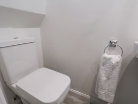 A bathroom with a toilet and towel holder at Beachcrest in Whitby
