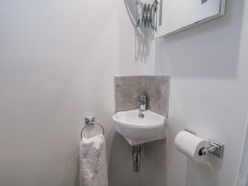A bathroom with a sink and mirror at Beachcrest in Whitby