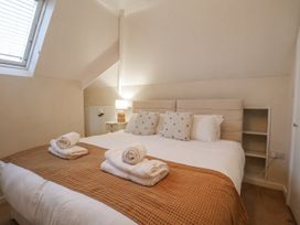 A bedroom with a double bed and side table at Beachcrest in Whitby