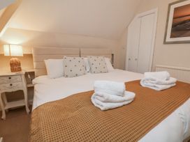 A bedroom with a large bed and bedside table at Beachcrest in Whitby