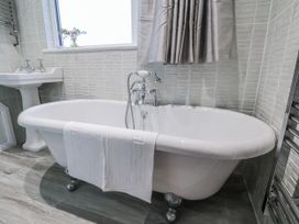 A bathroom with a bathtub and sink at Beachcrest in Whitby