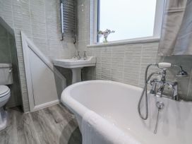 A bathroom with a bathtub, sink, and toilet at Beachcrest in Whitby