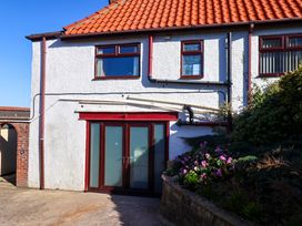 An outdoor view of a house facade with a door and windows at Beachcrest in Whitby