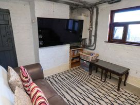A snug with a sofa and television at Beachcrest in Whitby
