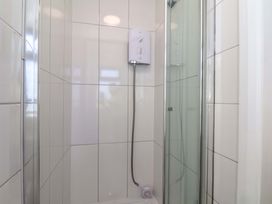 A shower with tiles and a water heater at Beachcrest in Whitby