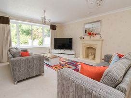 A living room with a television and sofa at Raincliffe Manor in Scarborough