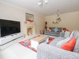 A living room with a television and sofa at Raincliffe Manor in Scarborough