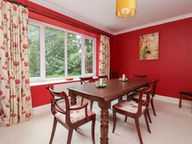 A dining room with a wooden table and chairs at Raincliffe Manor in Scarborough