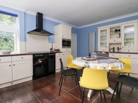 A kitchen with a table and four chairs at Raincliffe Manor in Scarborough