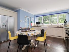 A kitchen with a table and chairs at Raincliffe Manor in Scarborough