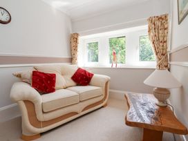 A living room with a sofa and lamp at Raincliffe Manor in Scarborough