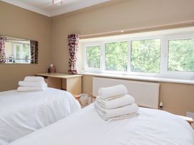 A bedroom with two beds and towels on top at Raincliffe Manor in Scarborough