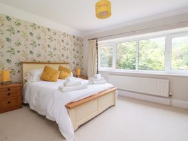 A bedroom with a bed and large windows at Raincliffe Manor in Scarborough
