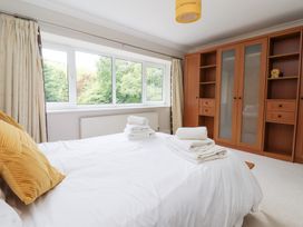 A bedroom with a bed and a wardrobe at Raincliffe Manor in Scarborough
