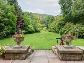 A garden with planters and lawn at Raincliffe Manor in Scarborough