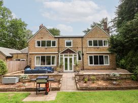 A house with a patio and lawn at Raincliffe Manor in Scarborough