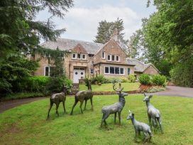 A house with deer statues in the front yard at Raincliffe Manor in Scarborough