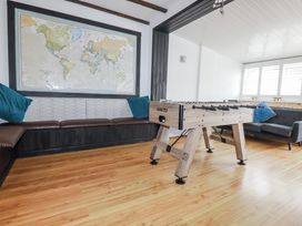 A recreation room with a foosball table and a world map at The Three Tees, Newquay