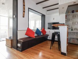 A living room with a sofa and television at The Three Tees in Newquay
