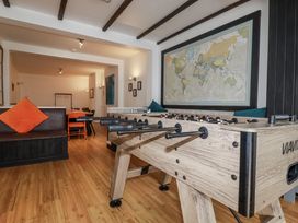 A living room with a foosball table and a map at The Three Tees in Newquay