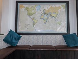 A sitting area with a world map on the wall at The Three Tees in Newquay