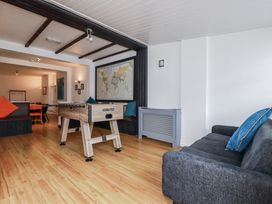 A living room with a foosball table and sofa at The Three Tees in Newquay