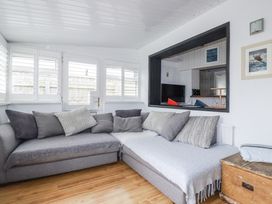 A living room with a sofa and television at The Three Tees in Newquay