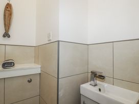 A bathroom with a sink and towel at The Three Tees in Newquay