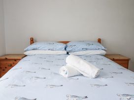 A bedroom with a bed and towels on it at The Three Tees in Newquay