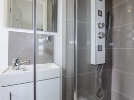 A bathroom with a shower and sink at The Three Tees in Newquay