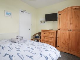 A bedroom with a bed and TV at The Three Tees in Newquay