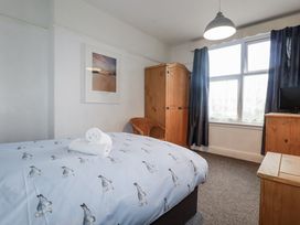 A bedroom with a bed and furniture at The Three Tees in Newquay